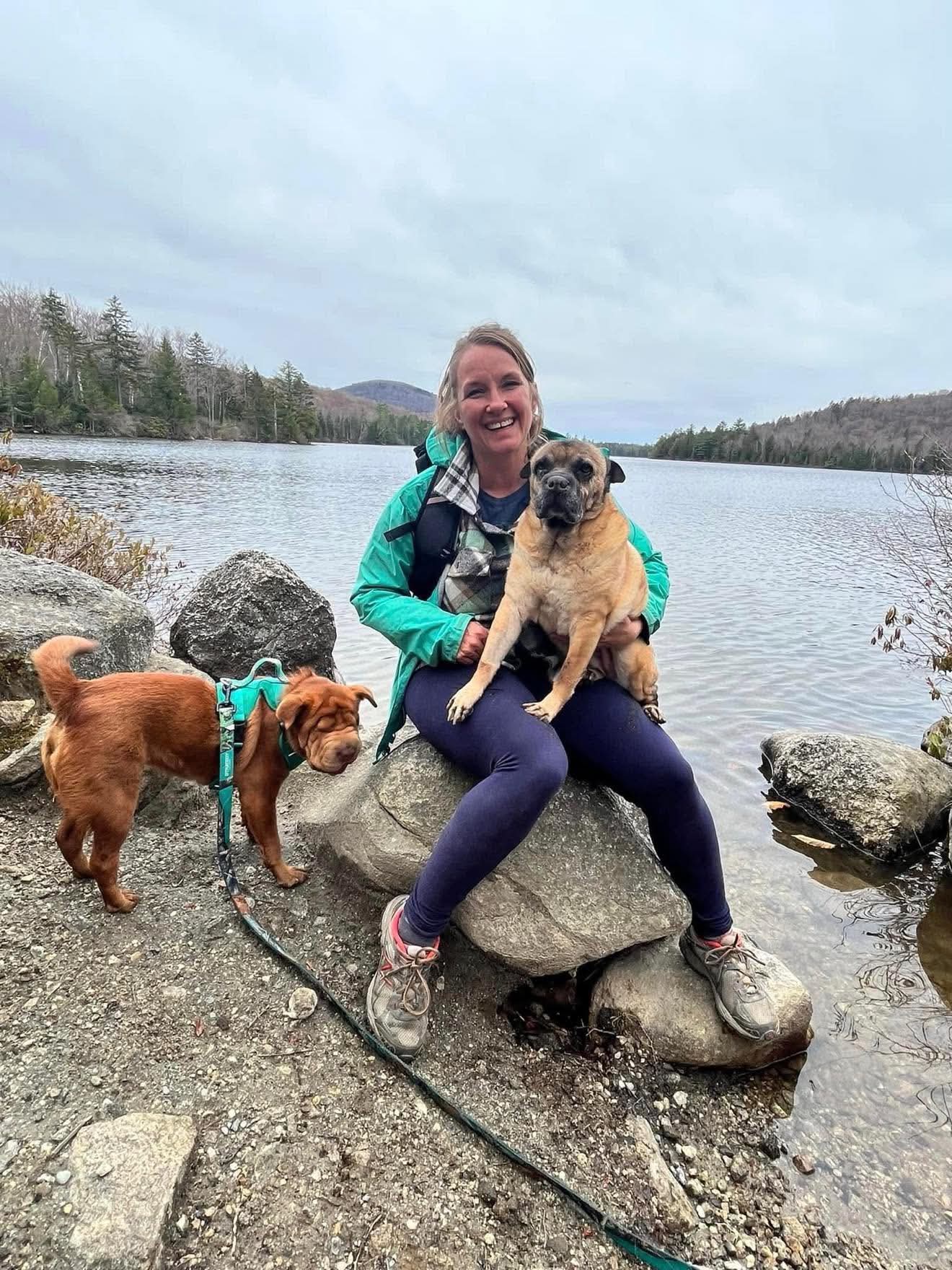 Heather Bent, Founder and Executive Director of Potter's Angels Rescue, on a Vermont lakeshore with two of her rescue dogs