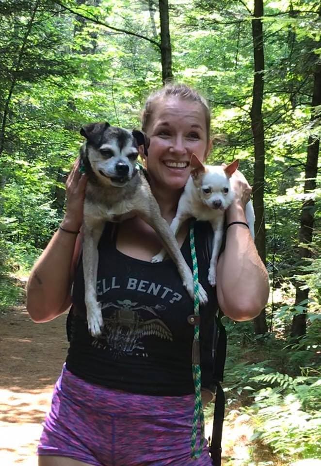 Heather Bent, Founder and Executive Director of Potter's Angels Rescue, on a Vermont trail with two of her rescue dogs